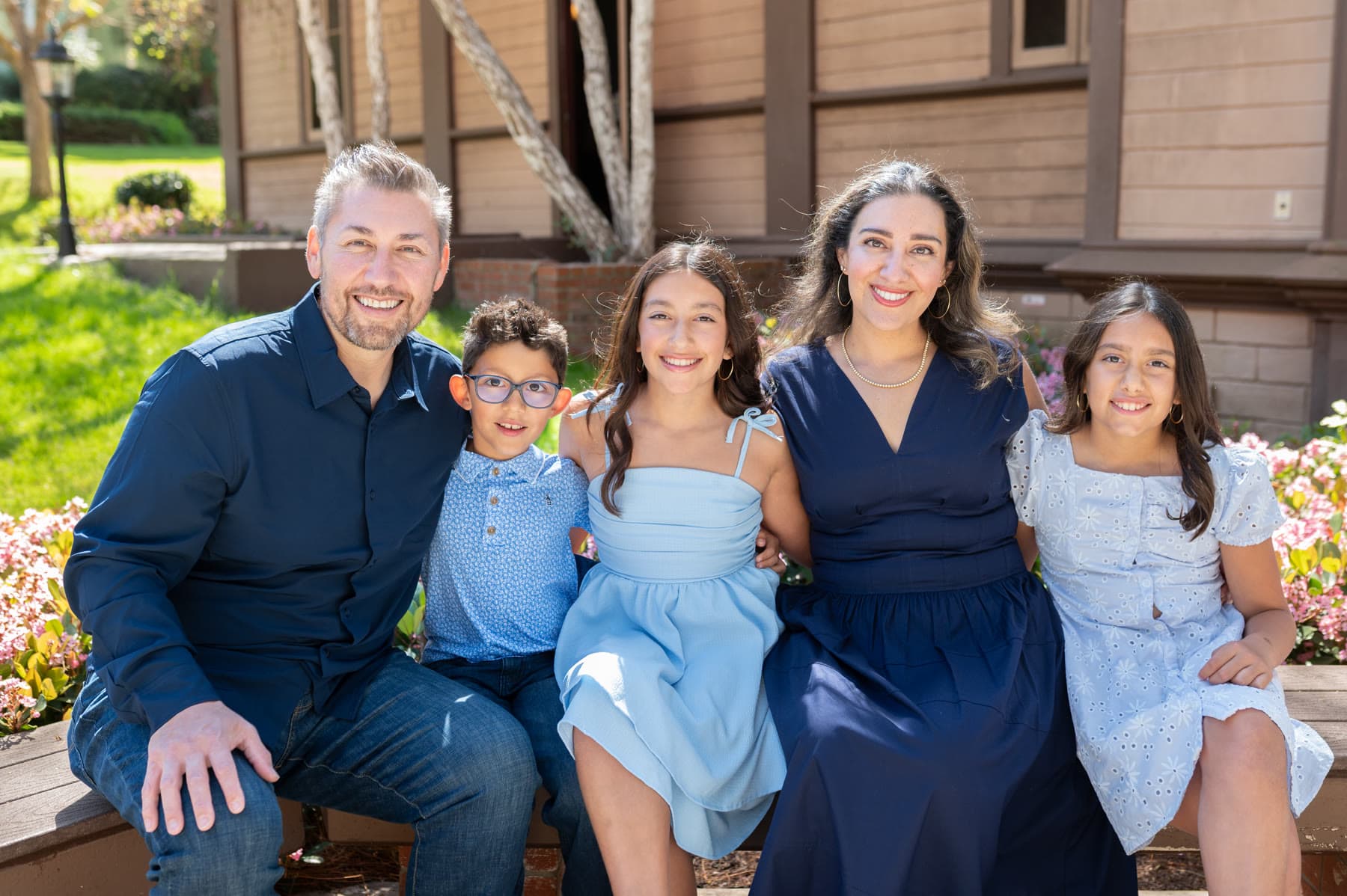 Dr. Paulo Cortes and Anaissa Cortes with their three children, photographed outdoors in San Diego.