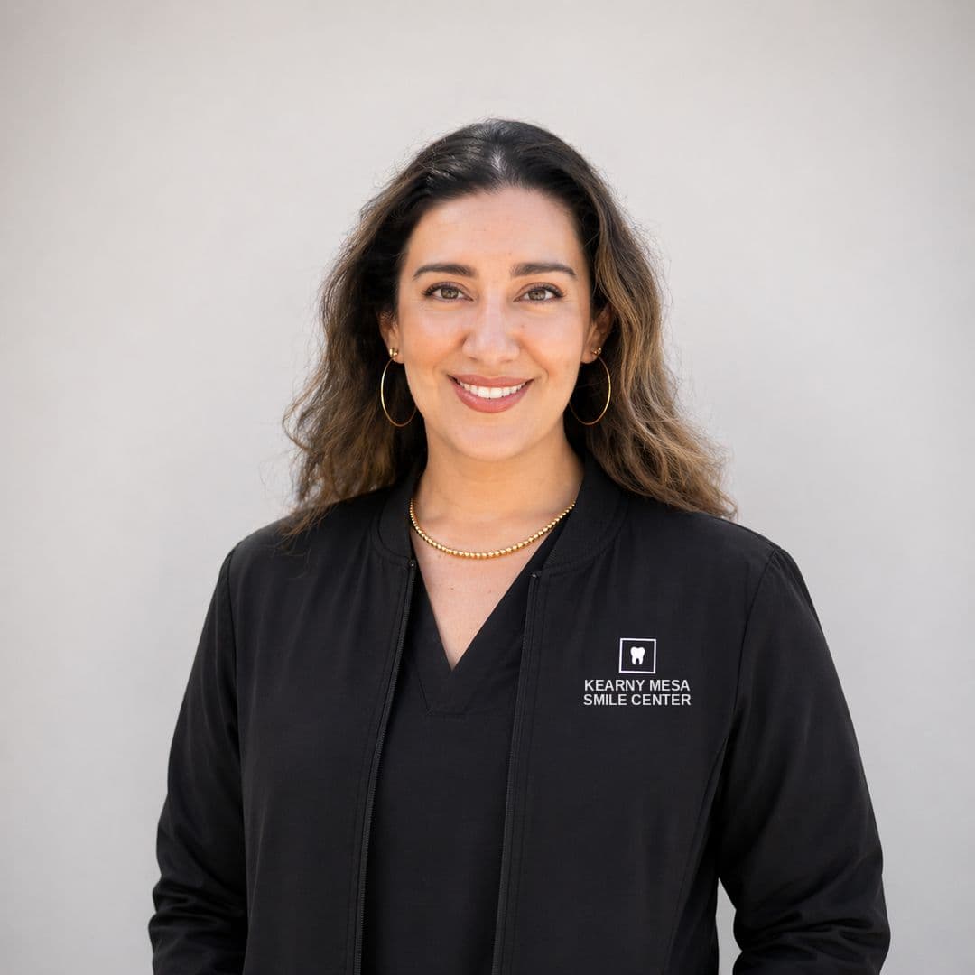 Studio portrait of Anaissa Cortes, COO and Co-Owner, in a Kearny Mesa Smile Center jacket