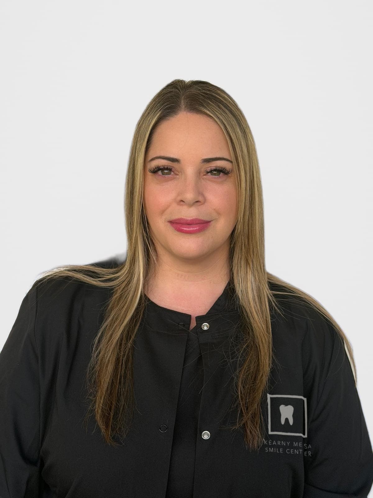 Studio portrait of Jasmine, Registered Dental Assistant, in a Kearny Mesa Smile Center jacket